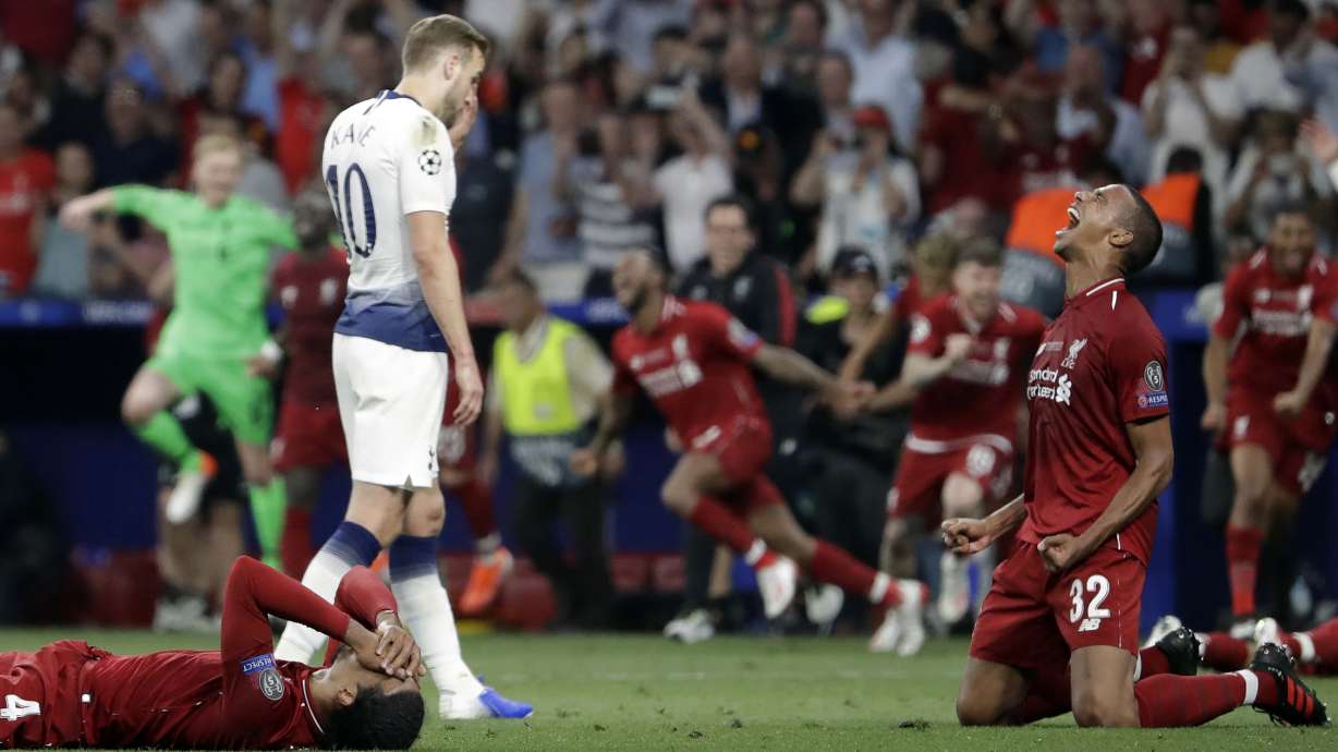 FILE - Tottenham's Harry Kane walks past Liverpool's players as they celebrate after winning the Champions League final soccer match against Tottenham Hotspur at the Wanda Metropolitano Stadium in Madrid, Saturday, June 1, 2019.