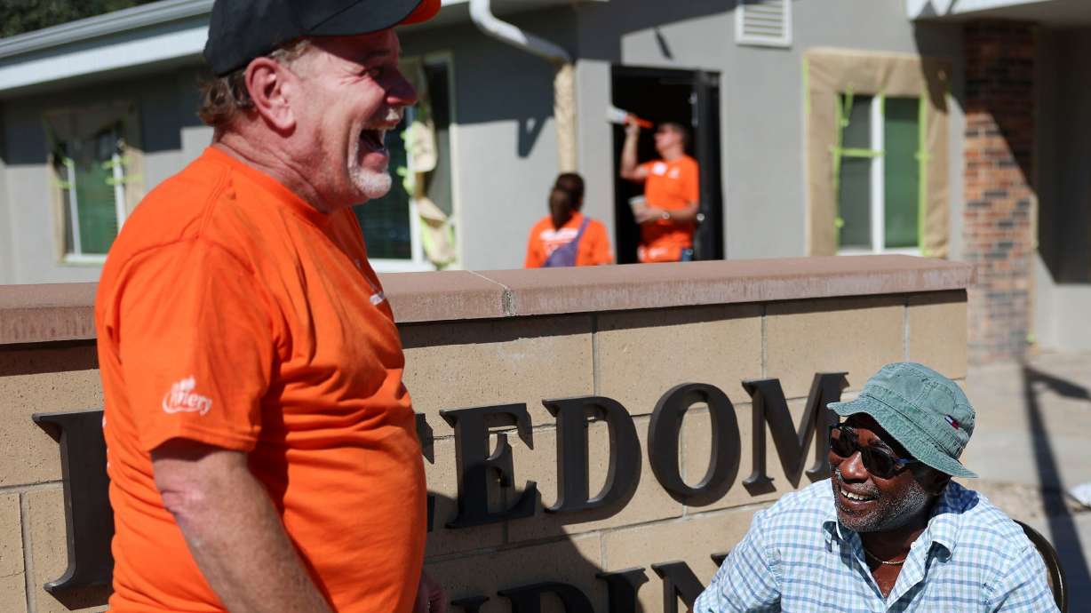 Home Depot vendor Steve Matthews, left, chats with Freedom Landing resident Kenneth Maxwell in Salt Lake City on Sept. 21, 2022. Saturday is Utah Social and Community Health Day, encouraging people to help others and ease isolation.