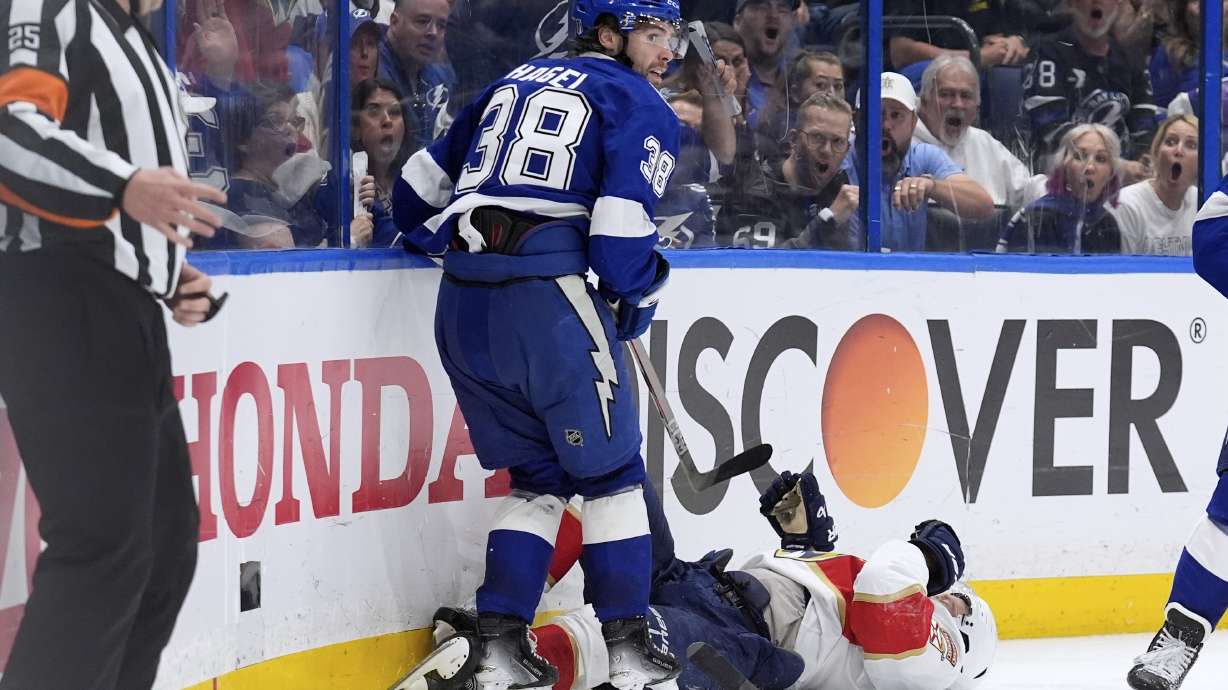 Tampa Bay Lightning left wing Brandon Hagel (38) takes down Florida Panthers center Aleksander Barkov during the third period in Game 2 of an NHL hockey Stanley Cup first-round playoff series, Thursday, April 24, 2025, in Tampa, Fla.