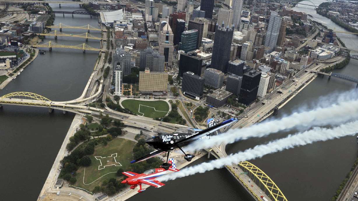 FILE - In this Thursday, Sept. 9, 2010, pilots Jack Knutson, flying an Extra 300 S, center left in red, and Rob Holland, flying a MX2, pass over downtown Pittsburgh.