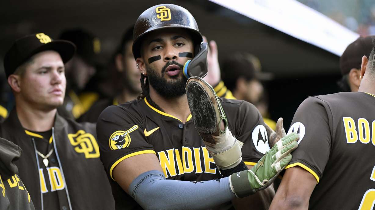 San Diego Padres' Fernando Tatis Jr. , center,is congratulated after scoring on a fielder's choice during the first inning of a baseball game against the Detroit Tigers, Monday, April 21, 2025, in Detroit.