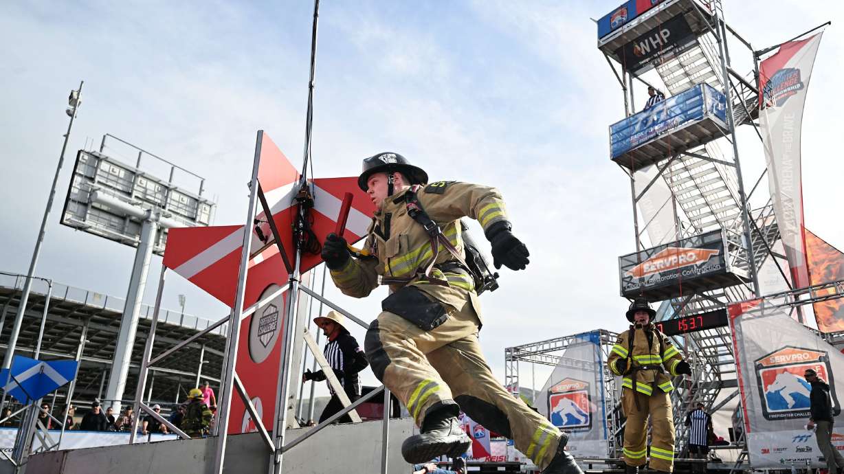 A firefighter runs around obstacles during the SERVPRO FCL 2025 West Region Classic in the TFT Firefighter Challenge Championship Series at the Utah State Fairpark in Salt Lake City on Friday.