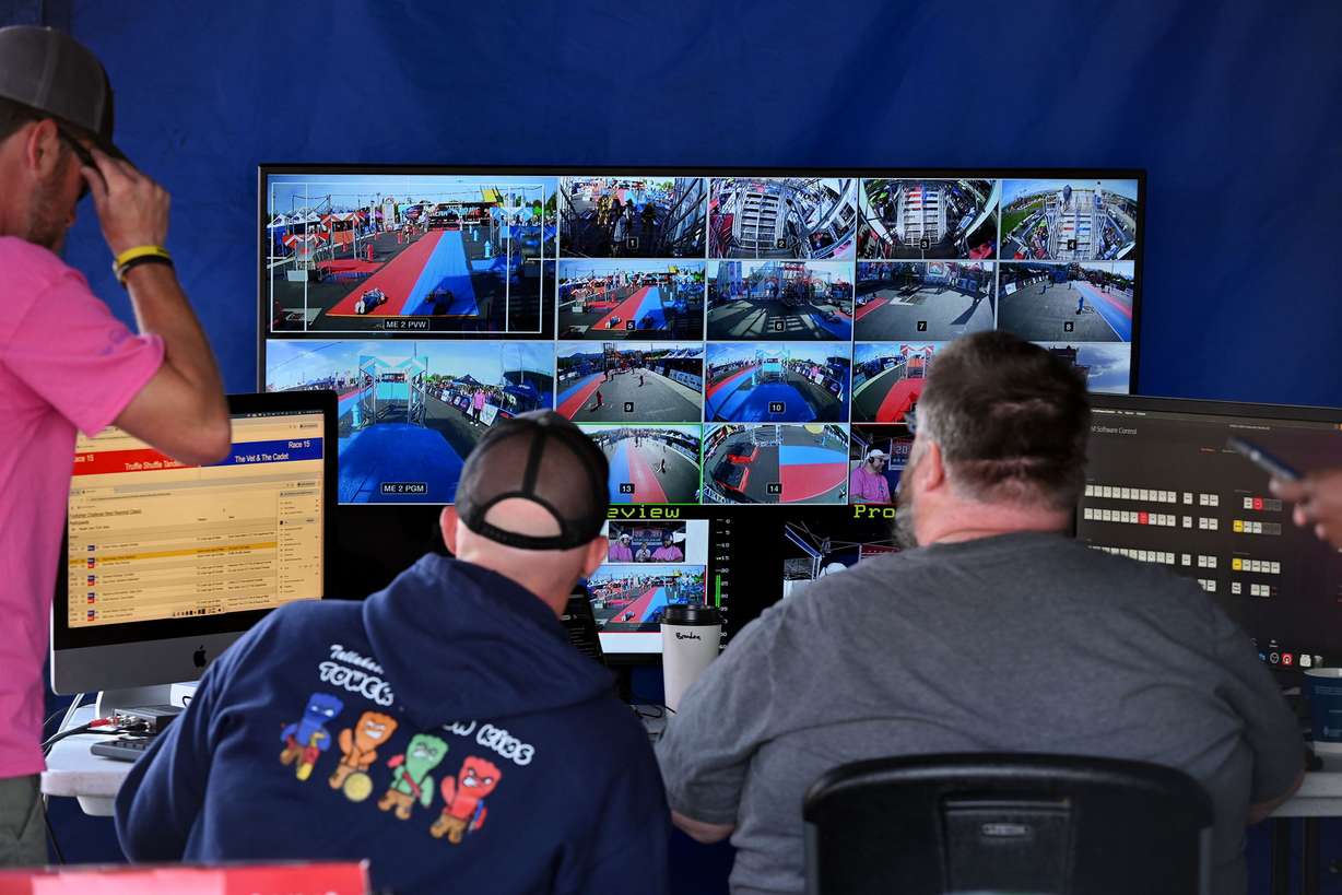 Broadcast crew members watch the numerous camera angles as firefighters compete in the SERVPRO FCL 2025 West Region Classic in the TFT Firefighter Challenge Championship Series, at the Utah State Fairpark in Salt Lake City on Friday