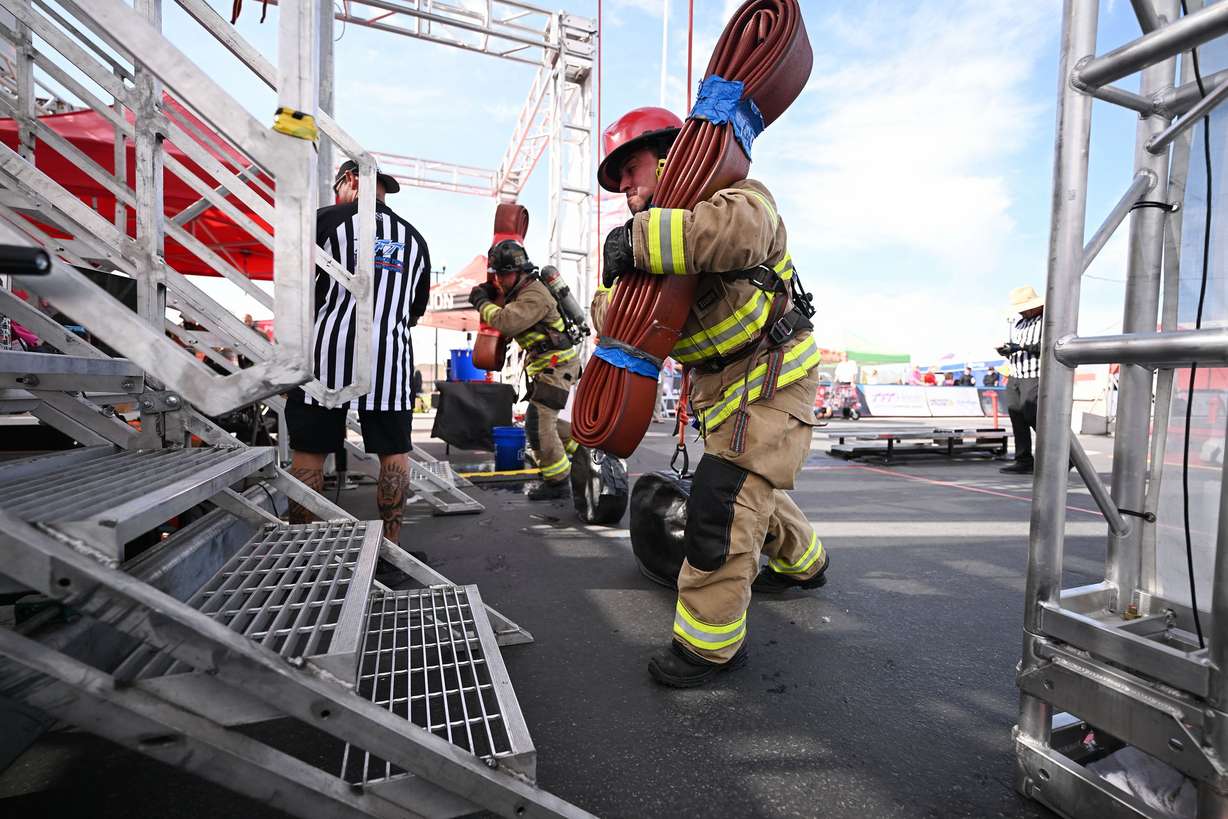 Firefighters compete for time in the SERVPRO FCL 2025 West Region Classic in the TFT Firefighter Challenge Championship Series, at the Utah State Fairpark in Salt Lake City on Friday.