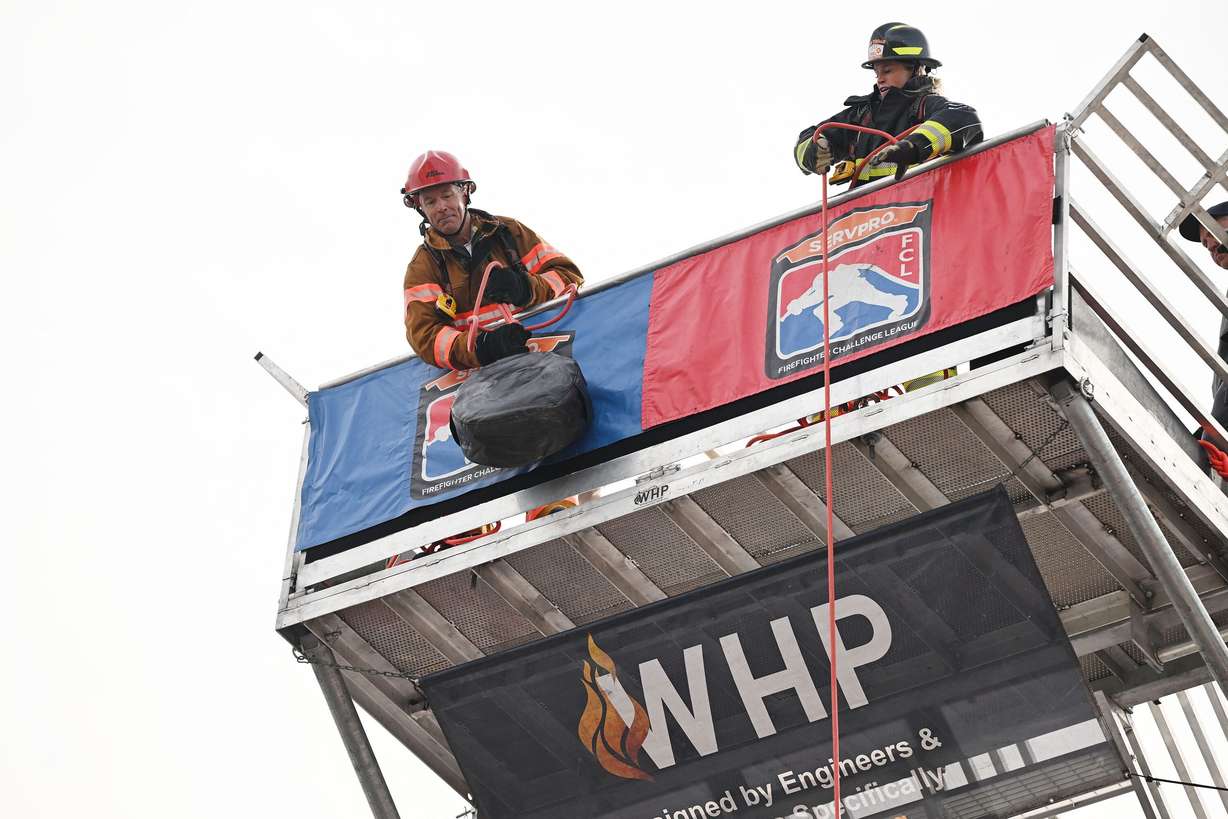 Firefighters compete for time in the SERVPRO FCL 2025 West Region Classic in the TFT Firefighter Challenge Championship Series, at the Utah State Fairpark in Salt Lake City on Friday.
