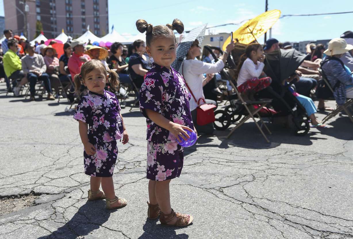 Etta Preece, 2, left, and Sadie, 3, right, pose for a photo while wearing traditional Japanese kimonos during the 13th annual Nihon Matsuri Japan Festival in Salt Lake City on April 27, 2019.