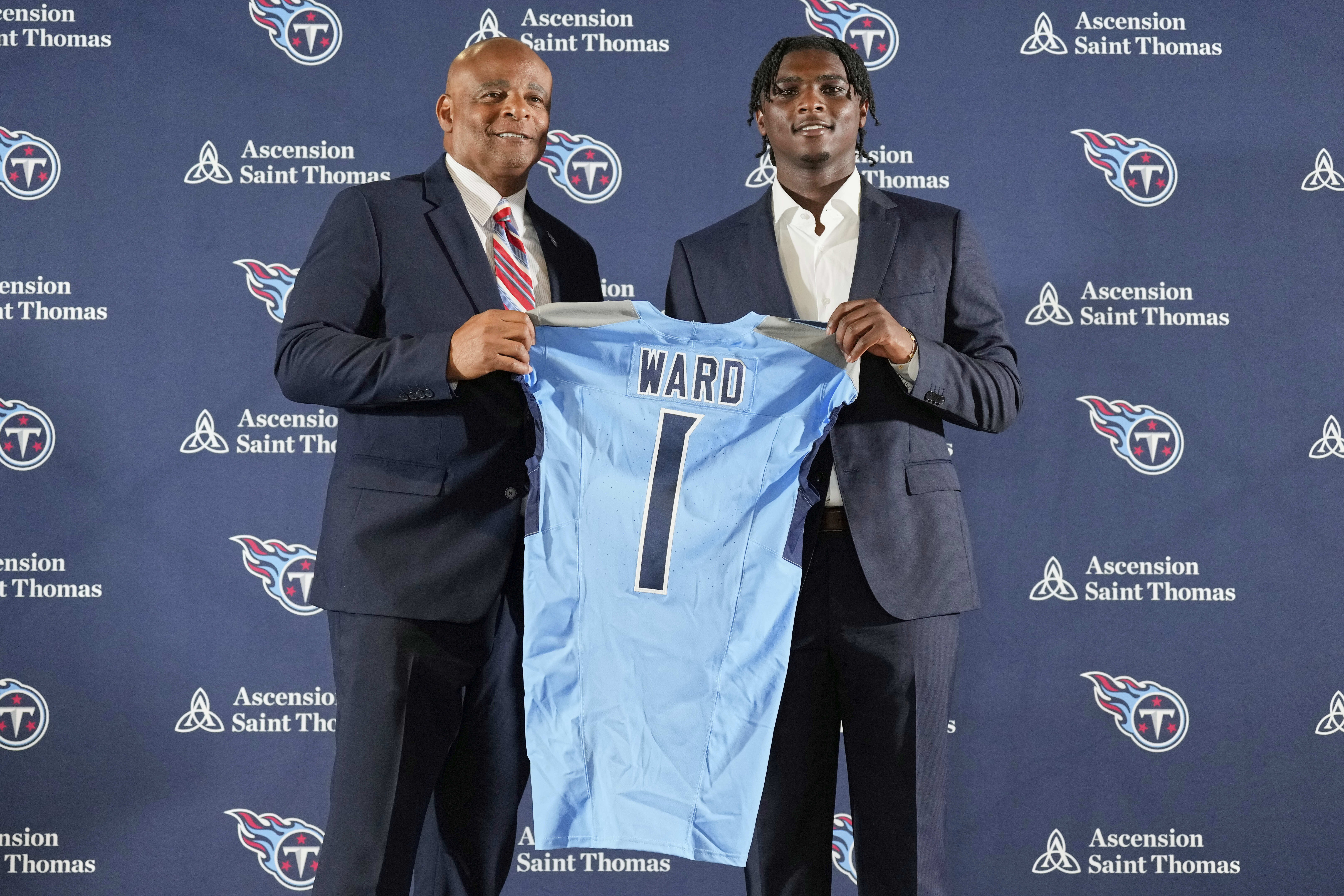 Former Houston Oilers quarterback Warren Moon, left, and quarterback Cam Ward, selected by the Tennessee Titans as the No. 1 overall pick in the NFL draft, pose during a news conference at the NFL football team's training facility, Friday, April 25, 2025, in Nashville, Tenn.
