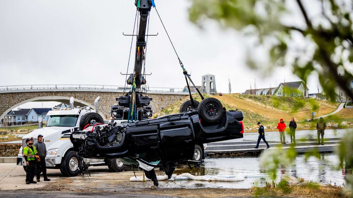Search and rescue teams look on after attaching a truck to be lifted out of the water after it flipped upside down in Oquirrh Lake in South Jordan on April 17. The driver of the truck died Thursday from injuries sustained in the crash.