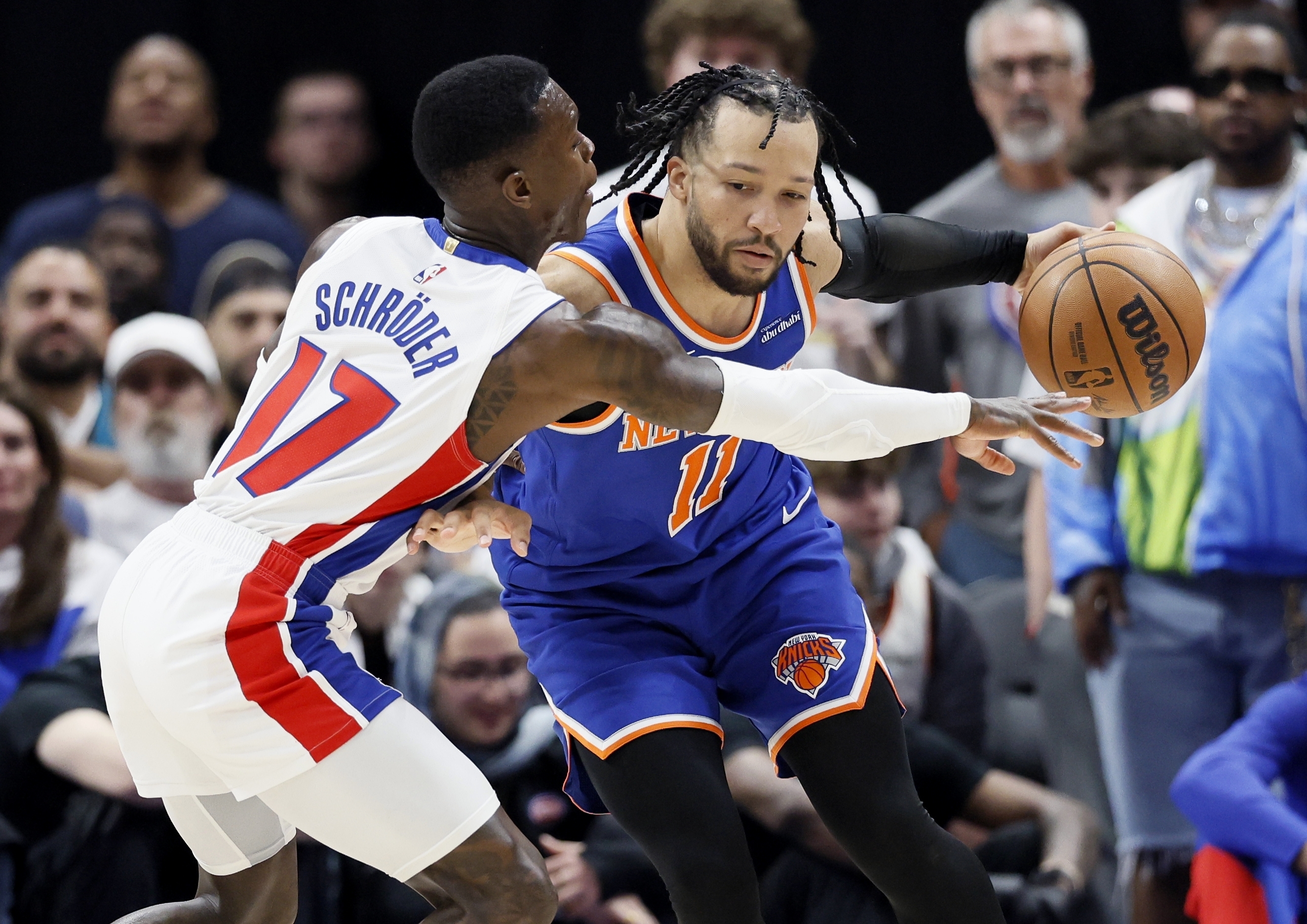 Detroit Pistons guard Dennis Schroder (17) tried to steal the ball from New York Knicks guard Jalen Brunson (11) during the second half of Game 3 of an NBA basketball first-round playoff series Thursday, April 24, 2025, in Detroit.