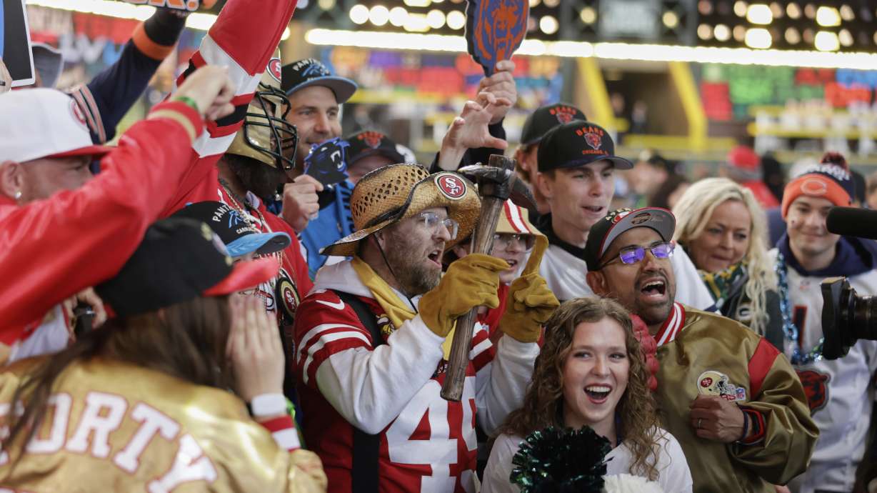 San Francisco 49ers and Chicago Bears fans cheer during the second round of the NFL football draft, Friday, April 25, 2025, in Green Bay, Wis.