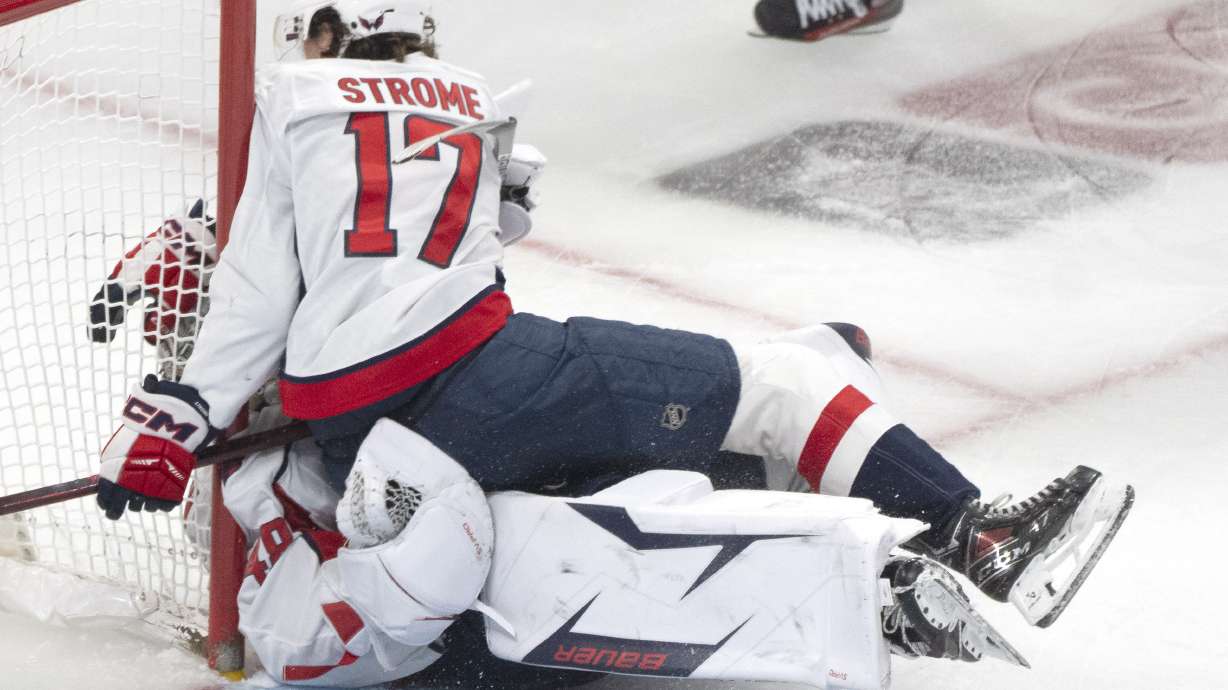 Washington Capitals' Dylan Strome (17) collides with goaltender Logan Thompson, bottom, during the third period of Game 3 of a first-round NHL hockey playoff series against the Montreal Canadiens in Montreal, Friday, April 25, 2025.
