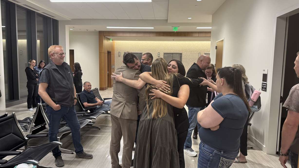 Odin Ratliff's parents hug members of the prosecution team following a guilty verdict against Kent Cody Barlow on Friday.