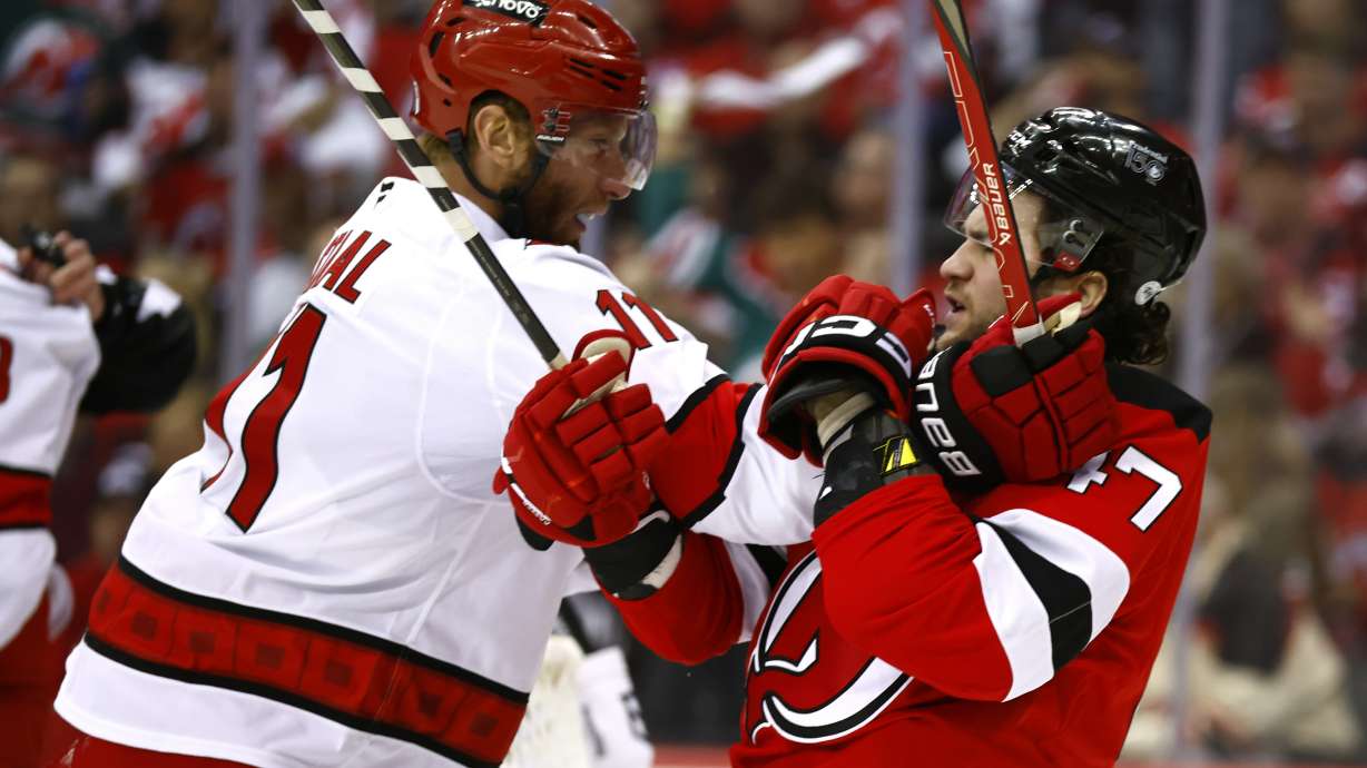 Carolina Hurricanes center Jordan Staal (11) and New Jersey Devils center Paul Cotter (47) fight during the first period of Game 3 of a first-round NHL hockey playoff series Friday, April 25, 2025, in Newark, N.J.