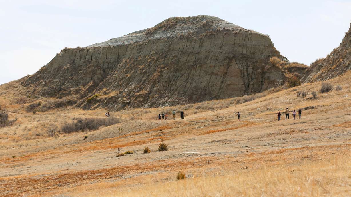 People hike in Three Affiliated Tribes National Park on the Fort Berthold Reservation in western North Dakota on April 11.