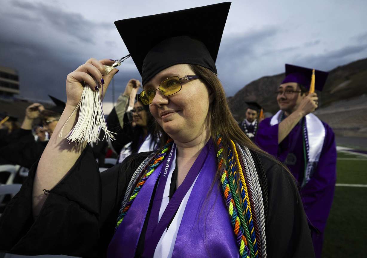 Ravenna Deahl, graduating with a bachelor’s in accounting, building design and construction management, moves her tassel to symbolize graduating during Weber State’s commencement ceremony at Stewart Stadium in Ogden on Friday.