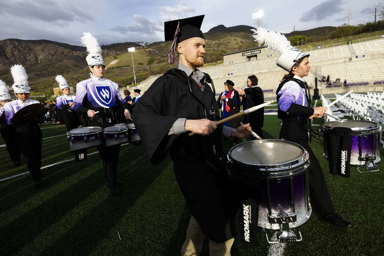 Nathanael Quimby, graduating with a bachelors in music, plays with the marching band during Weber State’s commencement ceremony at Stewart Stadium in Ogden on Friday.
