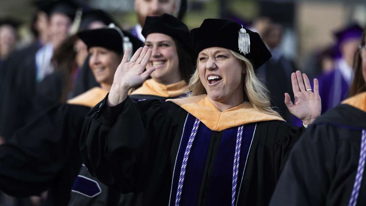 Graduates celebrate as they enter Weber State’s commencement ceremony at Stewart Stadium in Ogden on Friday.