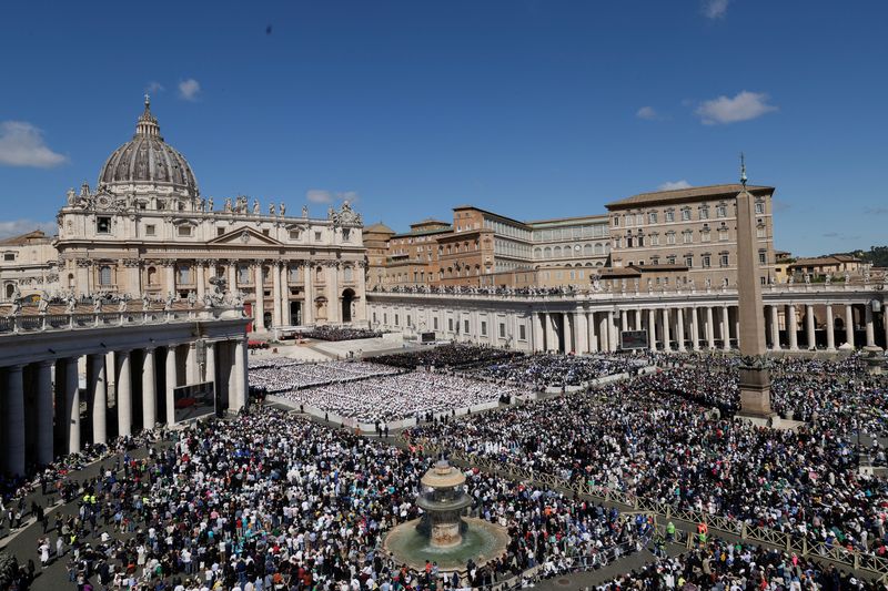 People attend the funeral Mass of Pope Francis in St. Peter's Square at the Vatican, Saturday.