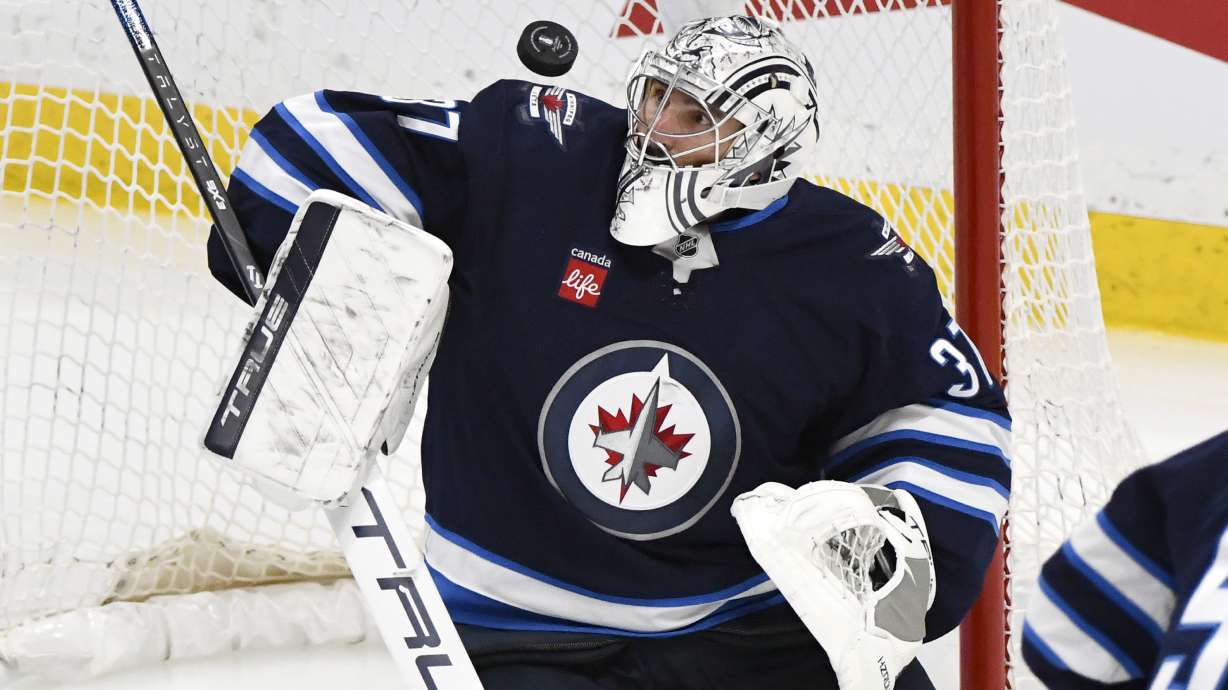 Winnipeg Jets goaltender Connor Hellebuyck (37) makes a save against a St. Louis Blues shot during the third period of Game 2 of a first-round NHL hockey playoff series in Winnipeg, Manitoba, Monday April 21, 2025.