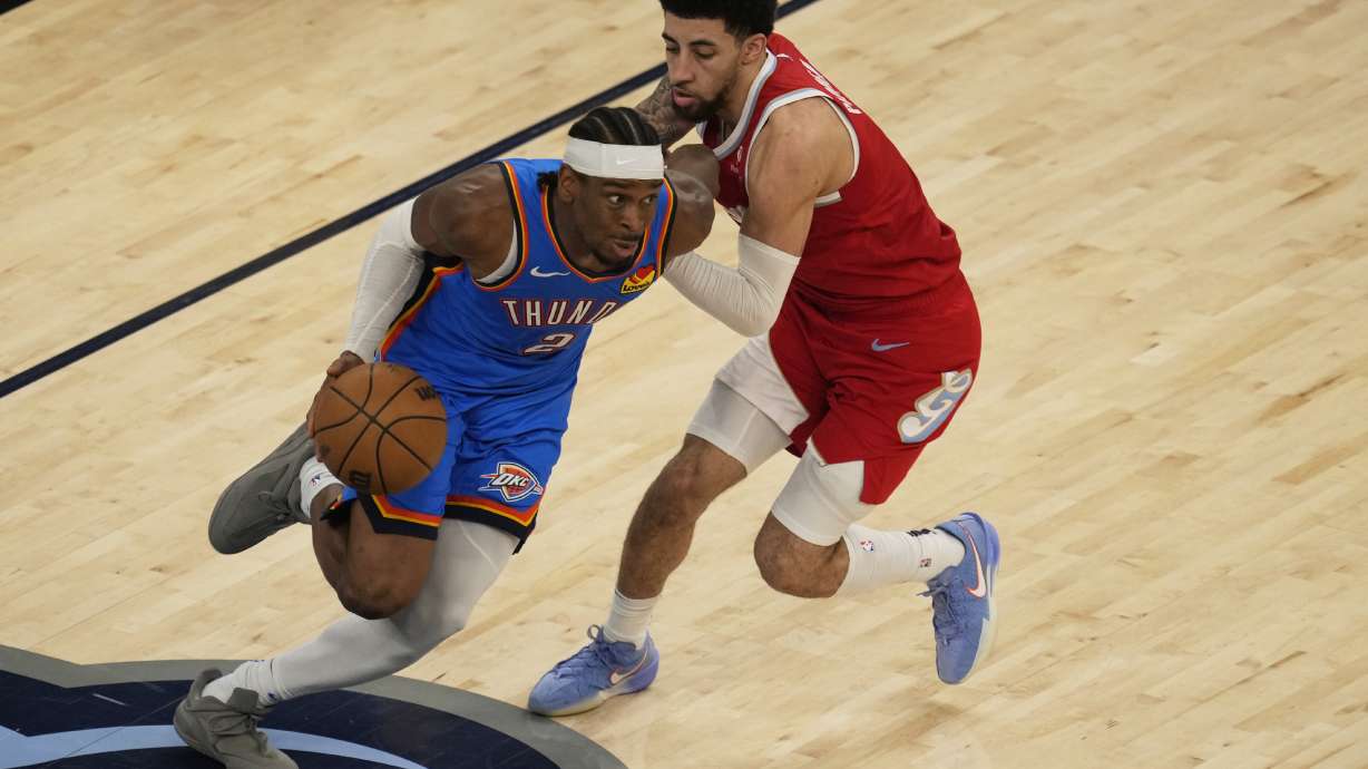 Oklahoma City Thunder guard Shai Gilgeous-Alexander (2) dribbles the ball past Memphis Grizzlies guard Scotty Pippen Jr., right, during the second half in Game 4 of an NBA basketball first-round playoff series Saturday, April 26, 2025, in Memphis, Tenn.