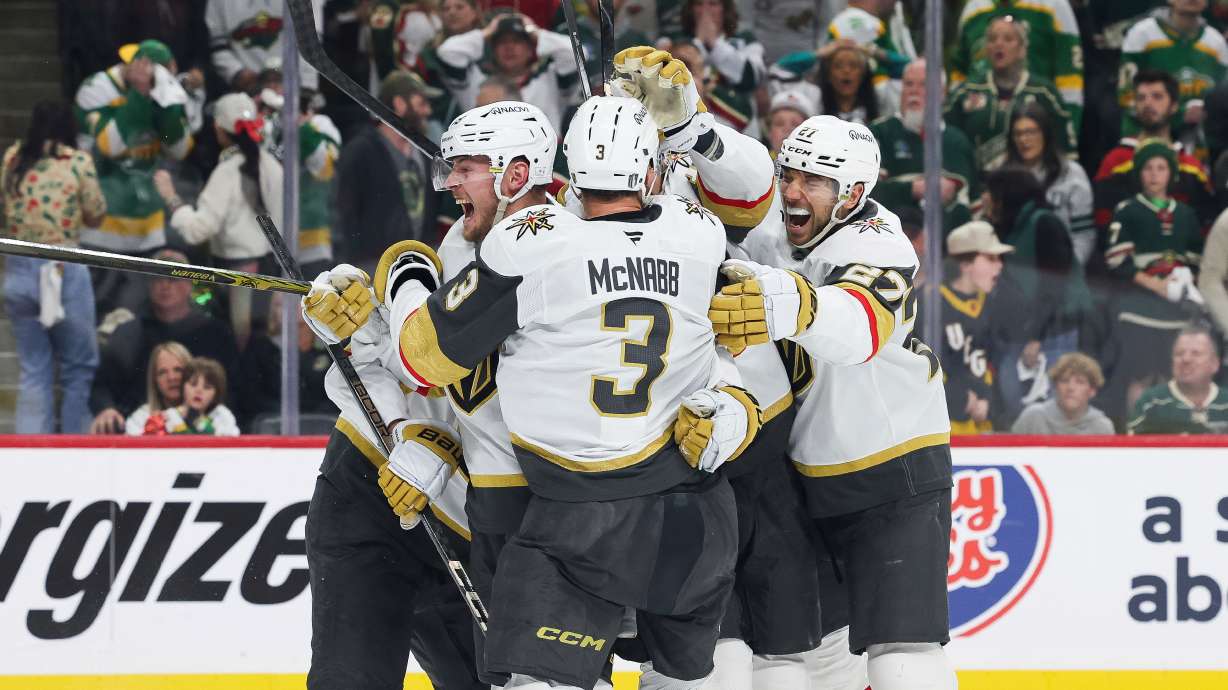 Vegas Golden Knights center Ivan Barbashev (49) celebrates with teammates after scoring a goal the winning goal during overtime in Game 4 of an NHL hockey Stanley Cup first-round playoff series against the Minnesota Wild, Saturday, April 26, 2025, in St. Paul, Minn.