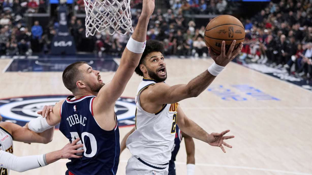 Denver Nuggets guard Jamal Murray, right, shoots as Los Angeles Clippers center Ivica Zubac defends during the first half in Game 4 of an NBA basketball first-round playoff series Saturday, April 26, 2025, in Inglewood, Calif.
