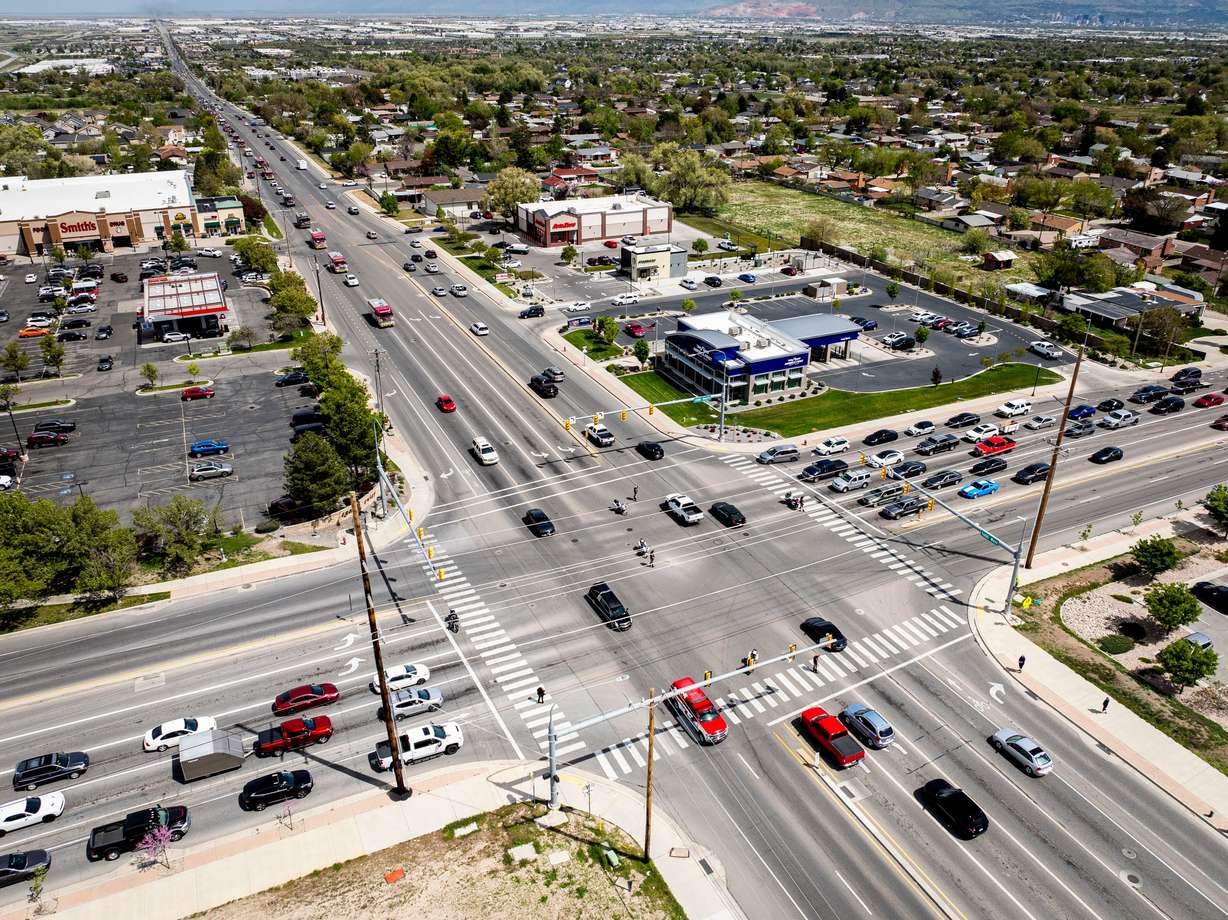 The funeral procession for the late South Jordan firefighter Corban Summers drives along 5600 West at the intersection with 4100 South on their way to Hunter High School in West Valley City for a memorial service on Saturday.
