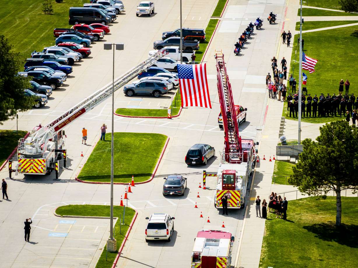 The funeral procession for the late South Jordan firefighter Corban Summers arrives at Hunter High School in West Valley City for a memorial service on Saturday.