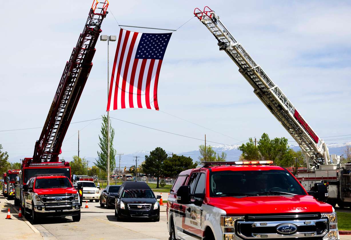 The hearse carrying the casket of South Jordan firefighter Corban Summers arrives for the funeral at Hunter High School in West Valley City on Saturday.