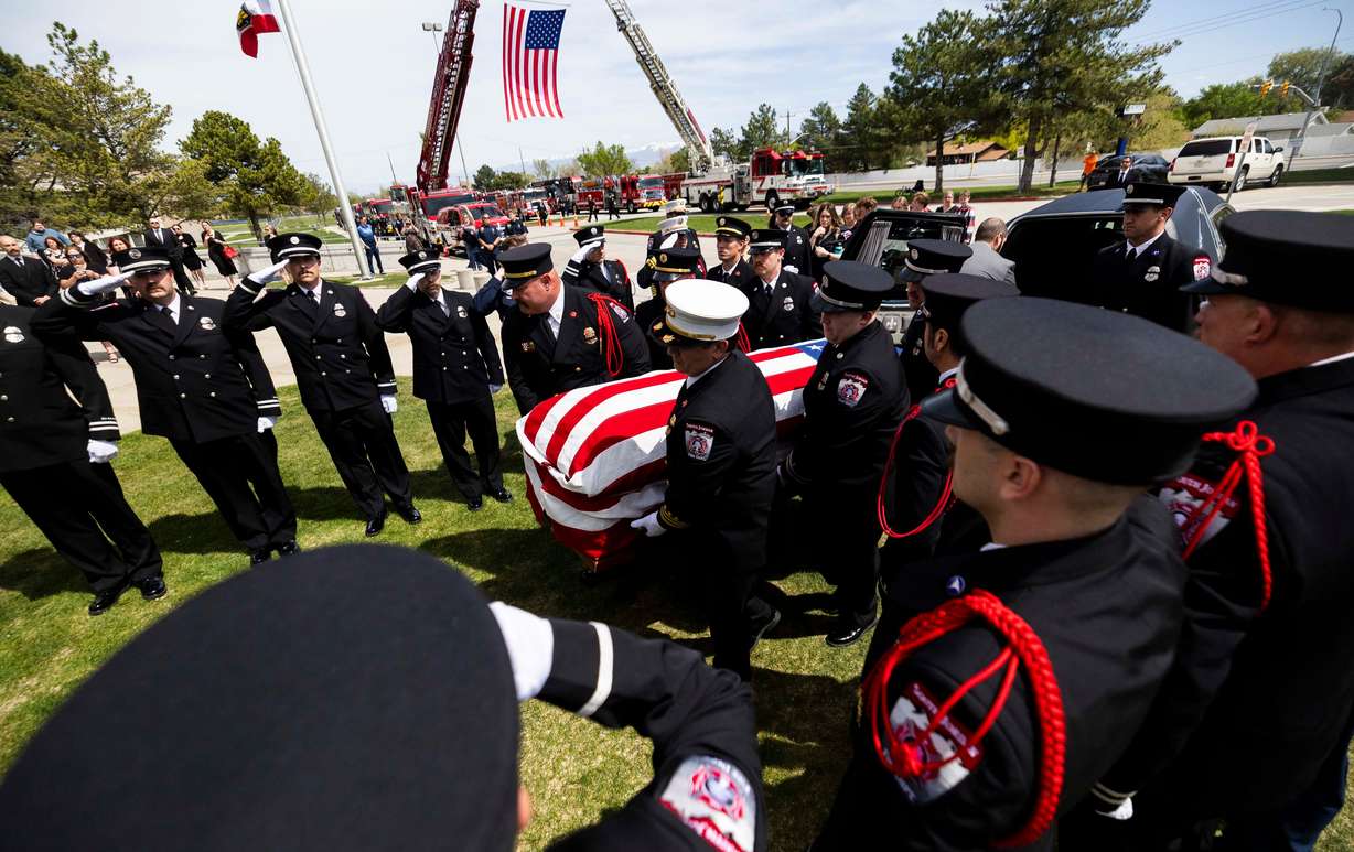 Pallbearers carry the casket of South Jordan firefighter Corban Summers into Hunter High School for his funeral in West Valley City on Saturday.