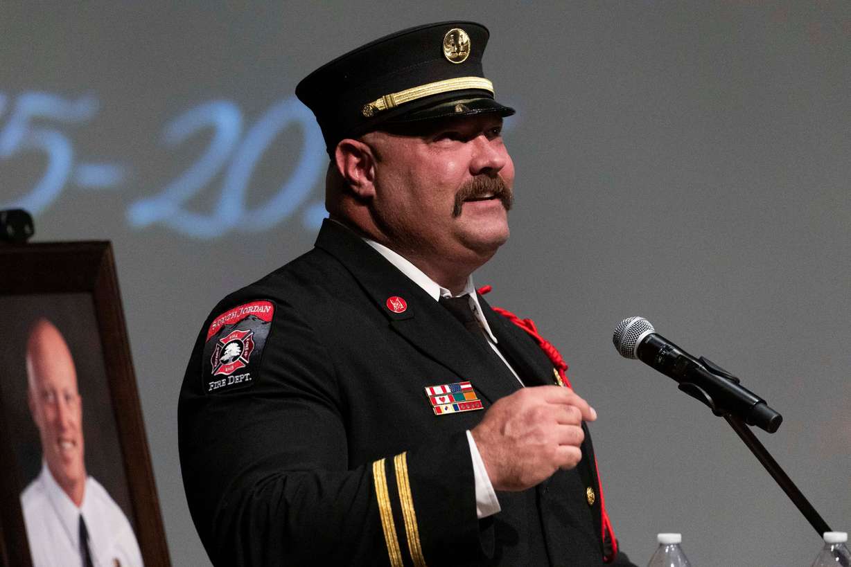South Jordan Fire Department Capt. Todd Cowley remembers a story about South Jordan firefighter Corban Summers while speaking during a funeral service for Summers at Hunter High School in West Valley City on Saturday.