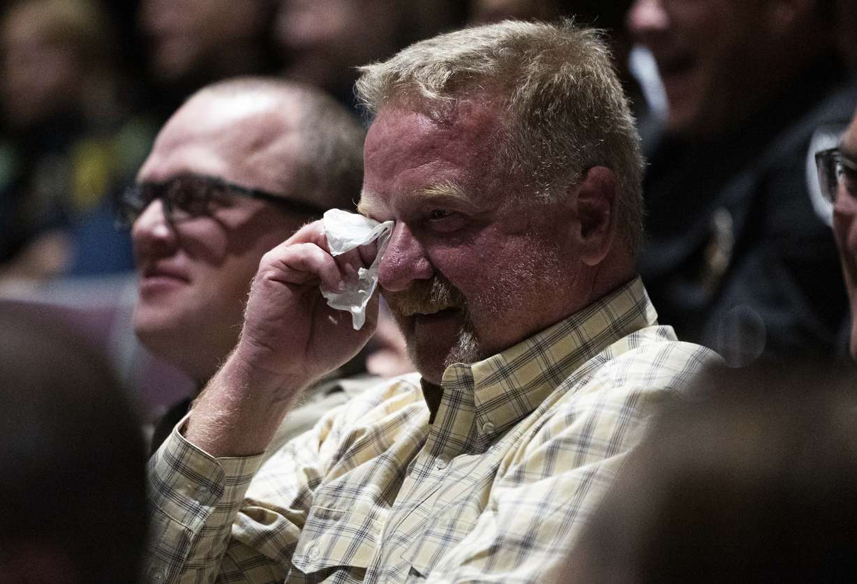 Retired South Jordan firefighter Jeremy Allen laughs and cries while a story about him and South Jordan firefighter Corban Summers is told during a funeral service for Summers at Hunter High School in West Valley City on Saturday.