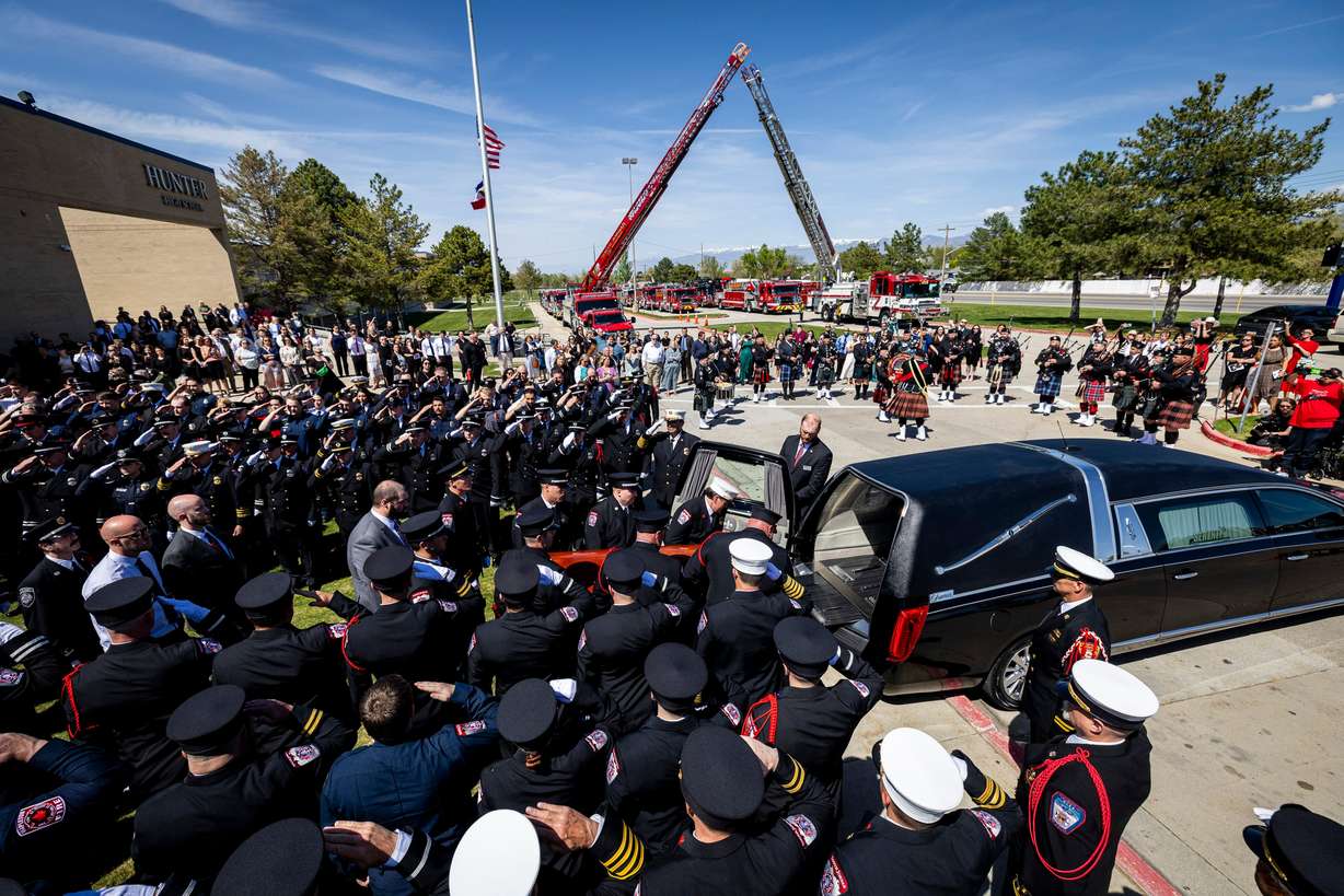 Pallbearers load the casket of the late South Jordan firefighter Corban Summers into a hearse after a memorial service held at Hunter High School in West Valley City on Saturday.