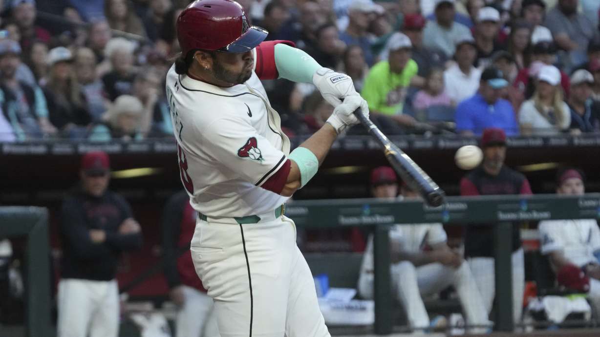 Arizona Diamondbacks' Eugenio Suárez hits a two-run home run against the Atlanta Braves in the fourth inning during a baseball game, Saturday, April 26, 2025, in Phoenix.