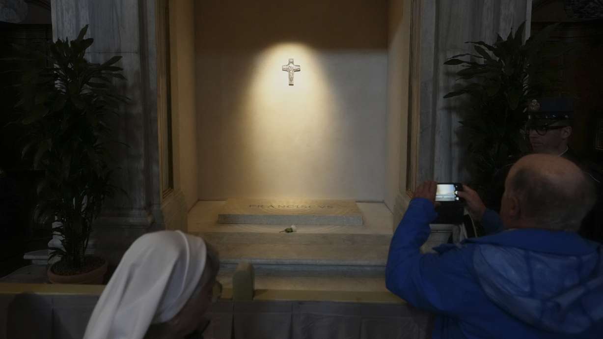 A man takes pictures of the tomb of Pope Francis as faithful are allowed inside St. Mary Major Basilica in Rome, Sunday.