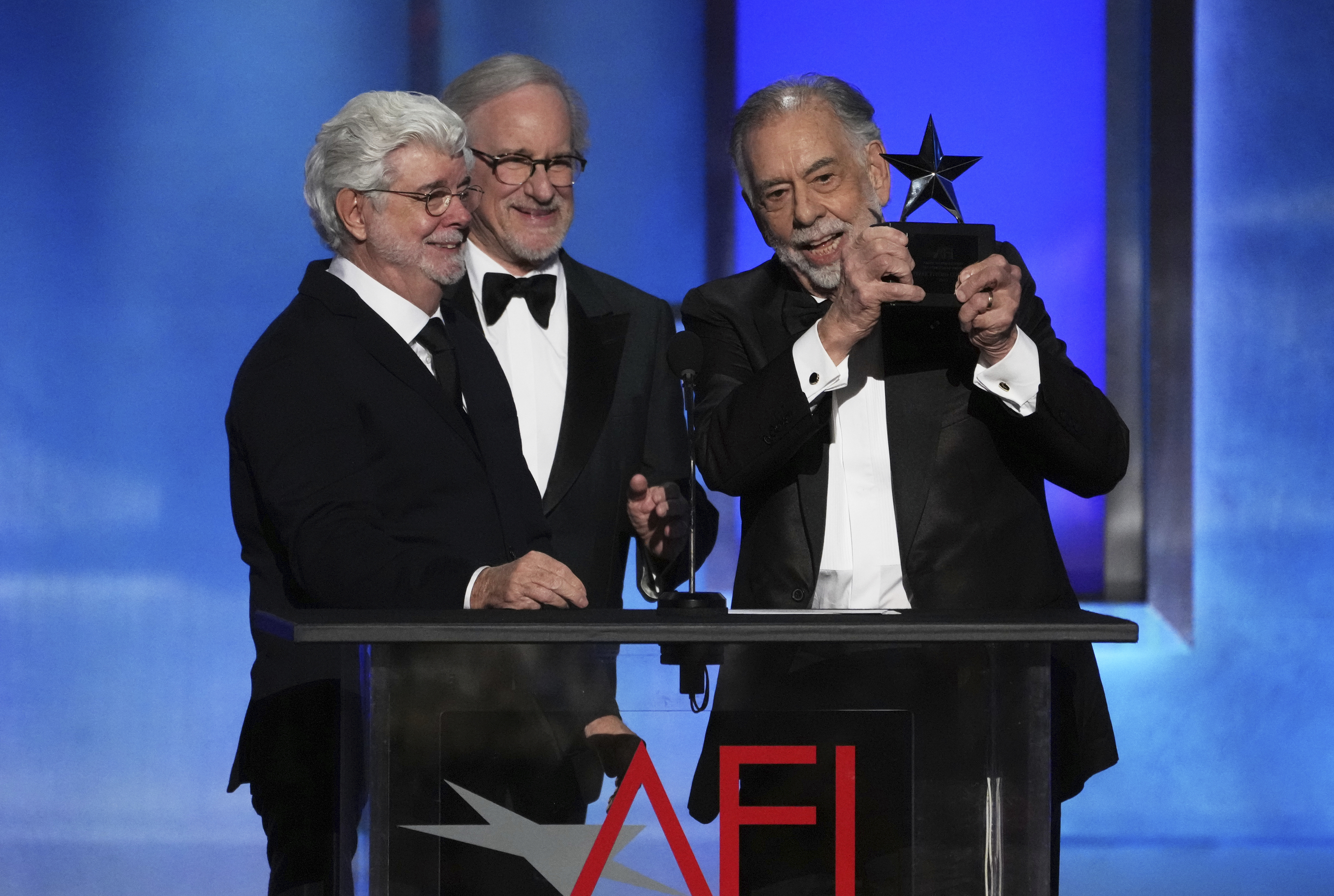 Filmmaker Francis Ford Coppola accepts the 50th AFI Life Achievement Award from presenters George Lucas and Steven Spielberg on Saturday at the Dolby Theatre in Los Angeles.
