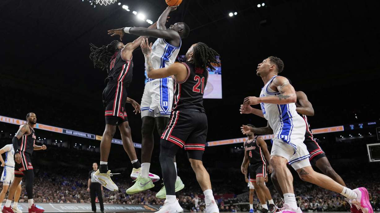 Duke center Khaman Maluach shoots over Houston forward Joseph Tugler during the first half in the national semifinals at the Final Four of the NCAA college basketball tournament, Saturday, April 5, 2025, in San Antonio.