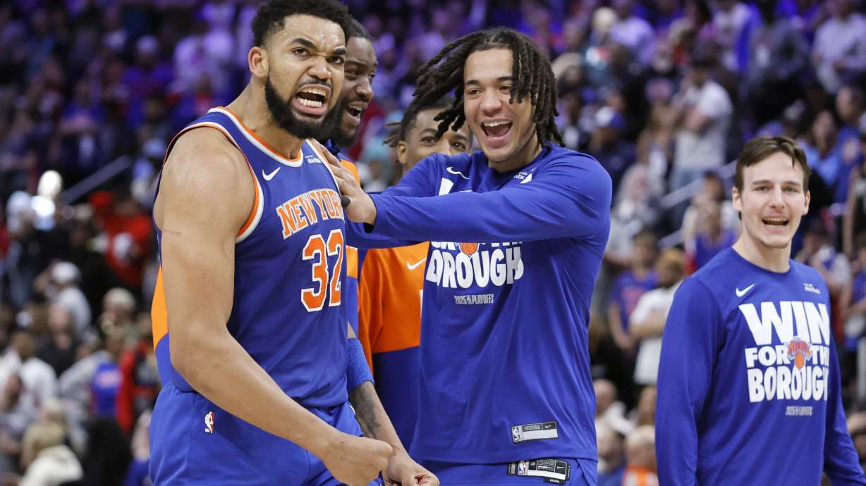 New York Knicks guard Pacome Dadiet, center, celebrates with center Karl-Anthony Towns (32) late in the fourth quarter of their win over the Detroit Pistons in Game 4 of an NBA basketball first-round playoff series Sunday, April 27, 2025, in Detroit.
