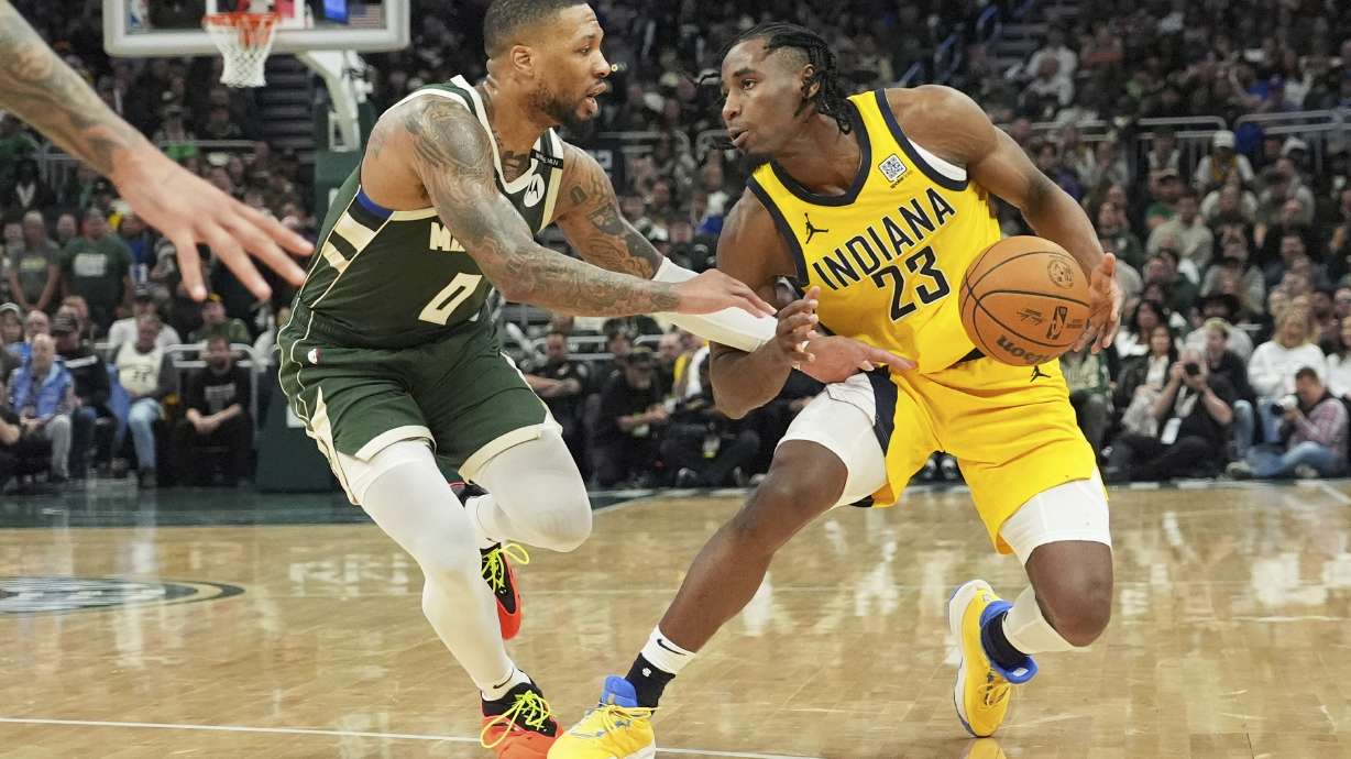 Milwaukee Bucks guard Damian Lillard, left, guards against Indiana Pacers forward Aaron Nesmith, right, during the second half in Game 3 of an NBA basketball first-round playoff series Friday, April 25, 2025, in Milwaukee.