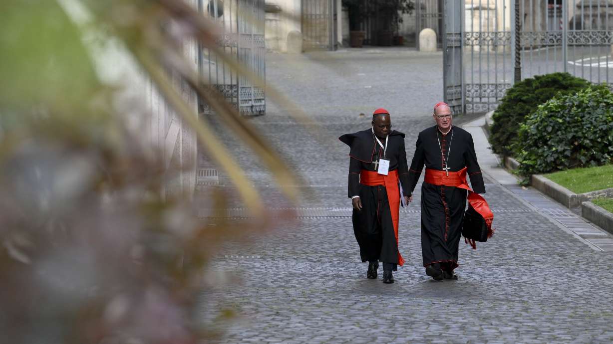 Cardinals Dieudonné Nzapalainga, left, and Timothy M. Dolan arrive for the Congregation of Cardinals in the New Hall of the Synod at the Vatican, Monday. The Vatican says the conclave to elect a successor to Pope Francis will begin on May 7.
