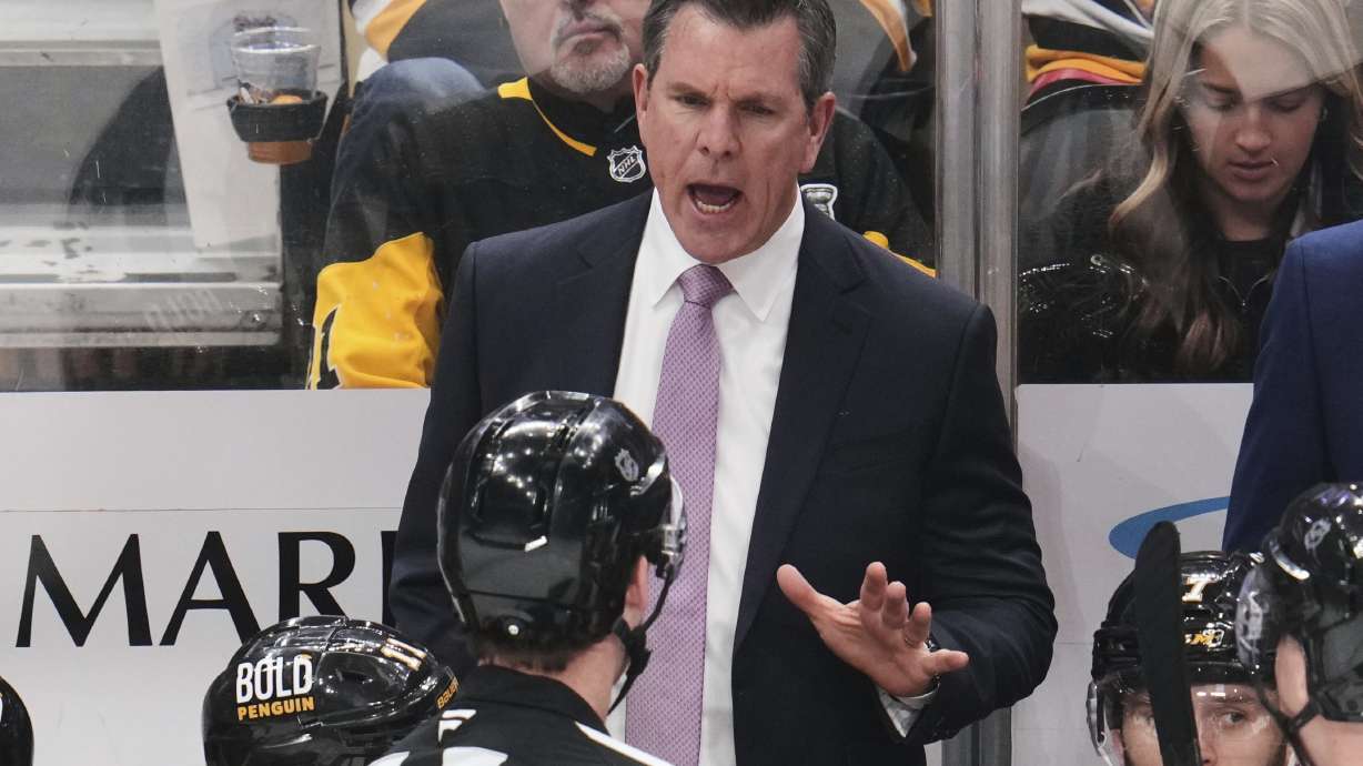 Pittsburgh Penguins head coach Mike Sullivan talks with referee Brandon Schrader during the third period of an NHL hockey game against the Washington Capitals in Pittsburgh, Thursday, April 17, 2025.