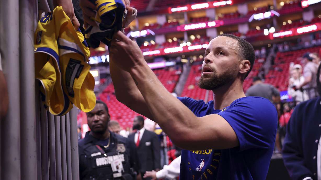 Golden State Warriors' Stephen Curry signs an autograph before playing the Houston Rockets in Game 2 of the first round of NBA Playoffs at Toyota Center in Houston, on Wednesday, April 23, 2025.