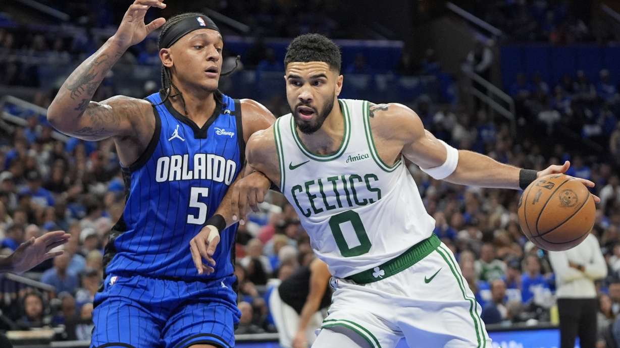 Boston Celtics forward Jayson Tatum (0) tries to get past Orlando Magic forward Paolo Banchero (5) during the first half in game 3 of a first-round NBA playoff basketball series,, Friday, April 25, 2025, in Orlando, Fla.