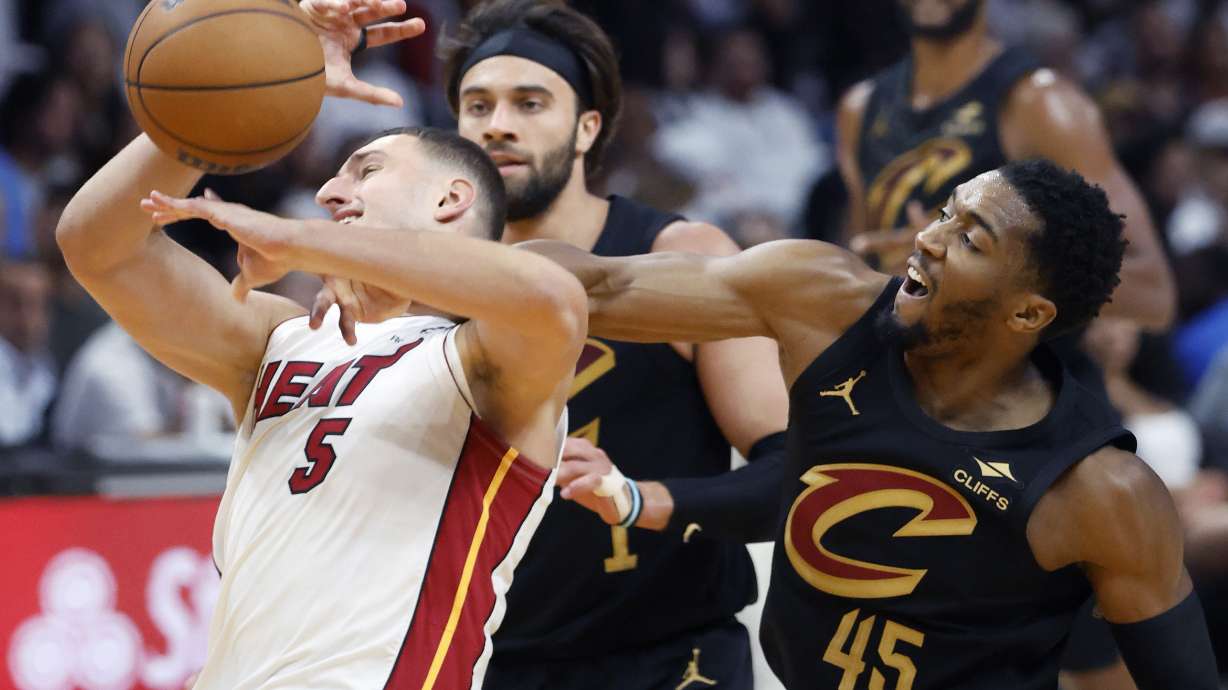 Cleveland Cavaliers guard Donovan Mitchell (45) fouls Miami Heat forward Nikola Jovic (5) during the first half in Game 4 of an NBA basketball first-round playoff series, Monday, April 28, 2025, in Miami.