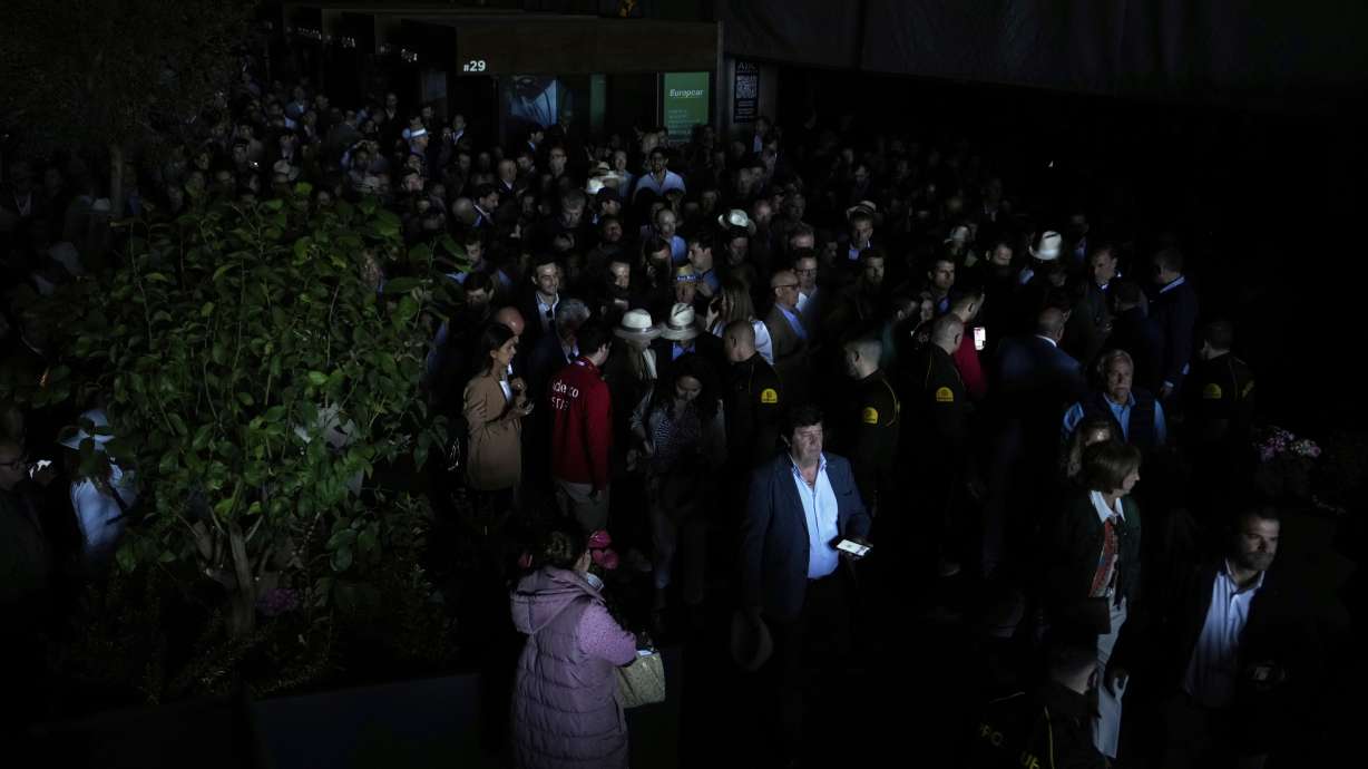 Spectators roam inside the Madrid Open tennis tournament venue during a general blackout in Madrid, Monday, April 28, 2025.