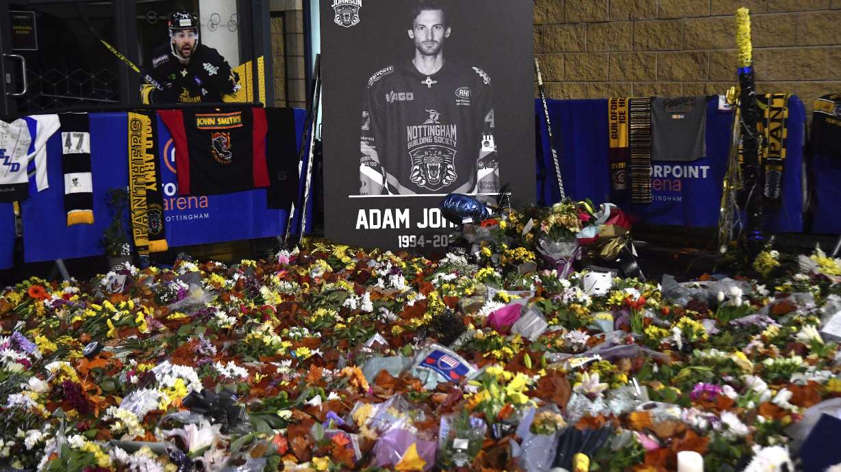 FILE - Floral tributes are placed for Nottingham Panthers player Adam Johnson, who died from a skate cut to the neck, outside the Motorpoint Arena, in Nottingham, England, Nov. 18, 2023, before a memorial ice hockey game between the Panthers and the Manchester Storm.