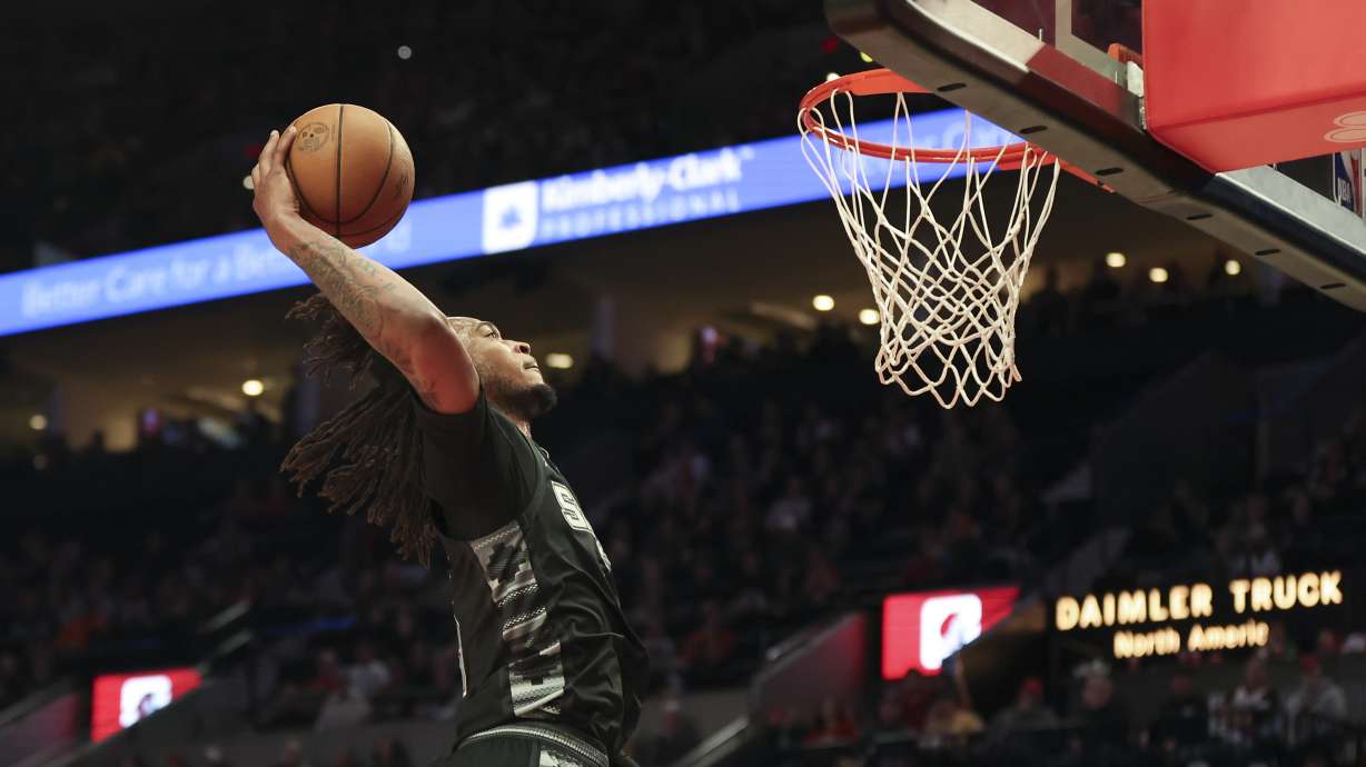 San Antonio Spurs guard Stephon Castle (5) dunks against the Portland Trail Blazers during the second half of an NBA basketball game Sunday, April 6, 2025, in Portland, Ore.