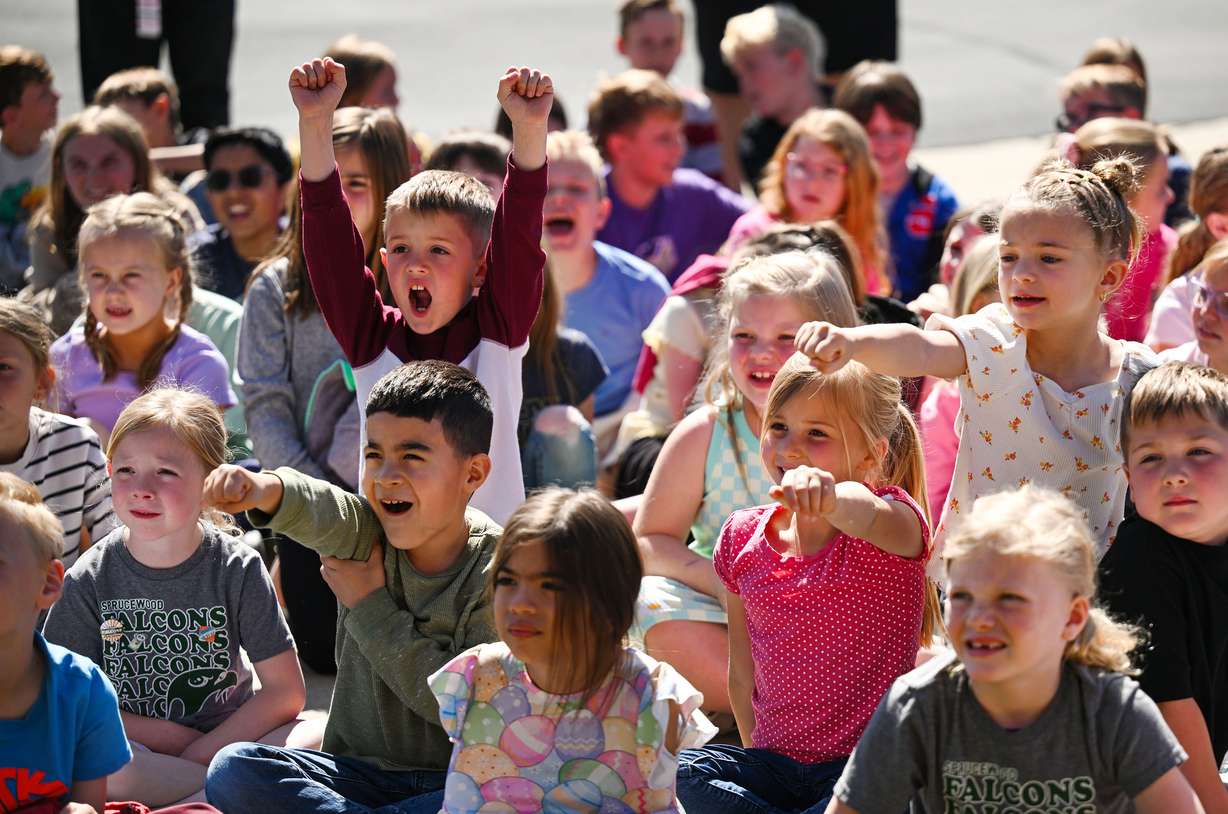 Students at Sprucewood Elementary School in Sandy react as they meet Smokey the Bear and participate in a "moon tree" planting on Tuesday.