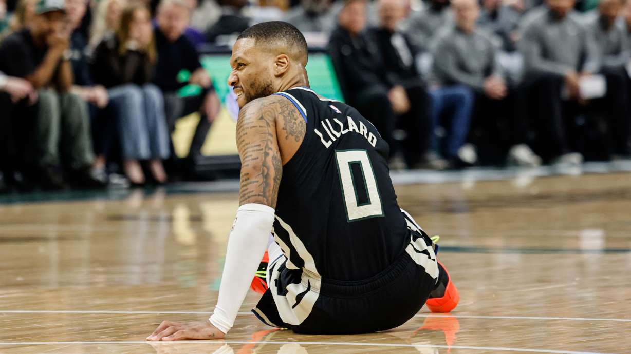 Milwaukee Bucks' Damian Lillard grimaces as he falls to the floor against the Indiana Pacers during the first half of Game 4 of a first-round NBA basketball playoff series Sunday, April 27, 2025, in Milwaukee.