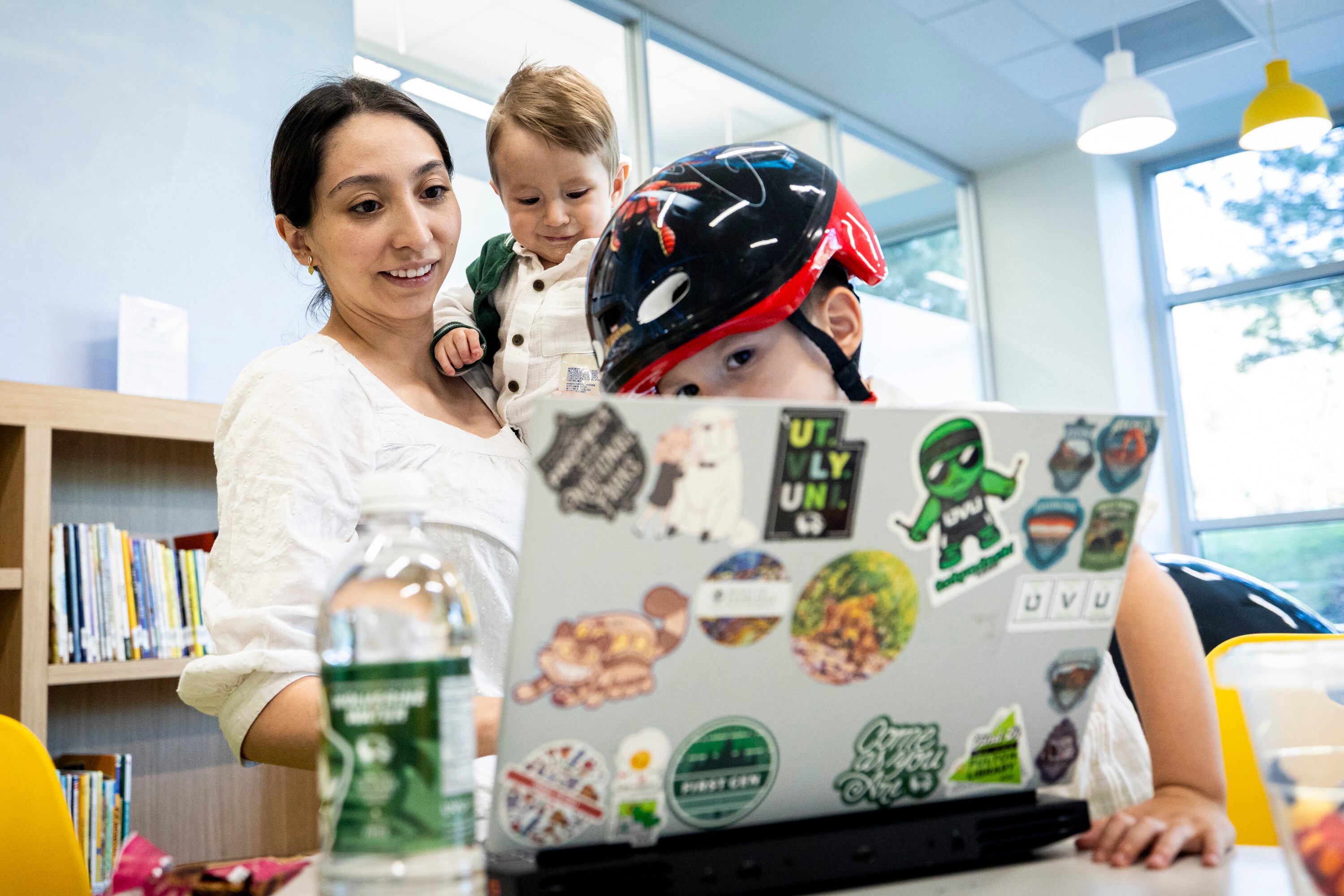 Michelle Jackson, a rising senior studying accounting, holds her son, Damian, 9 months, while joined by her other son, Jason, 2, as she studies for a final exam at the Fulton Library on the campus of Utah Valley University in Orem on Tuesday.